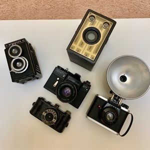 Collection of five vintage antique cameras.